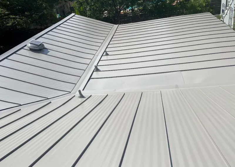 Solar attic fan installed on a metal roof for Roof Ventilation in Sturgeon Bay